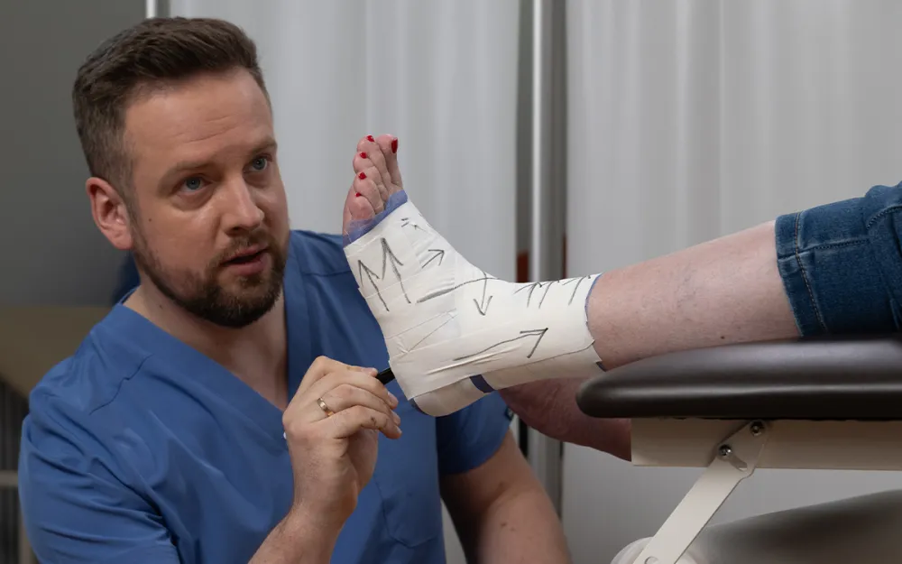 doctor examining patient's leg